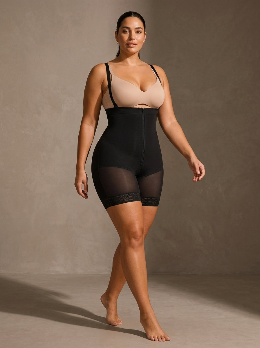 Editorial model wearing black waist-shaping shorts against a warm taupe studio backdrop — Tummy & Waist